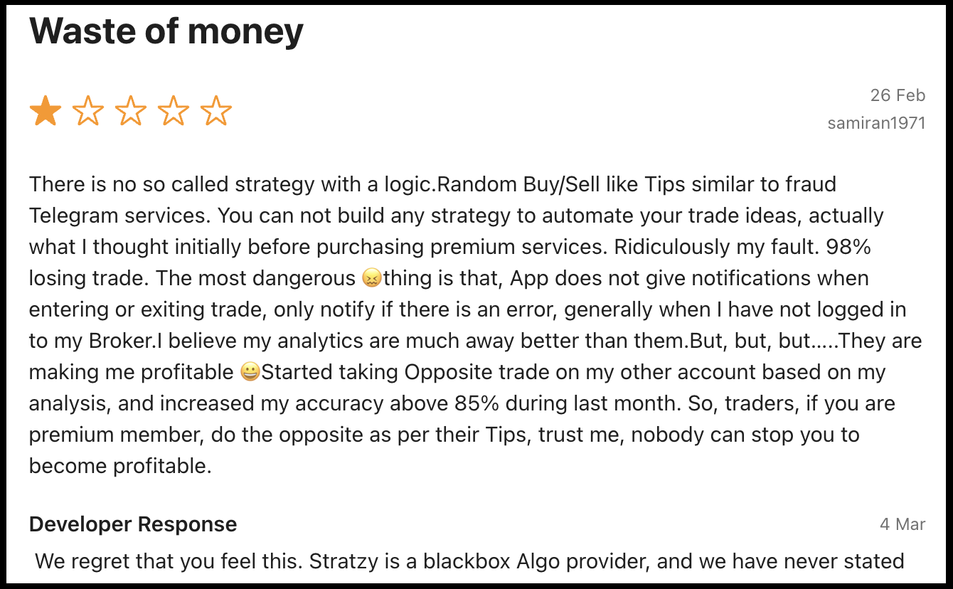 User review titled Waste of Money on Google Play alleging random trade signals and high loss rates on Stratzy.